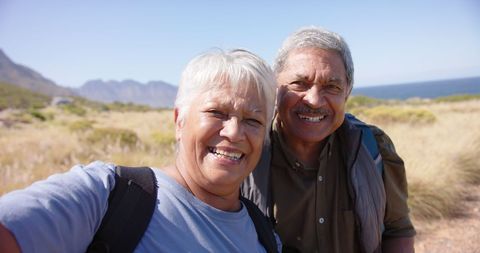 Happy Senior Couple Enjoying Hiking Adventure by the Sea - Download Free Stock Images Pikwizard.com