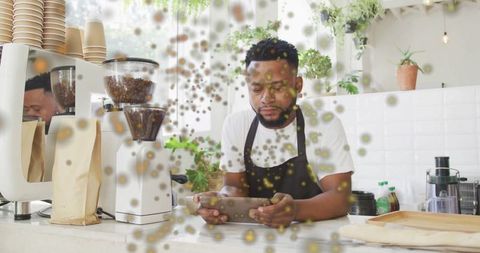 Barista Using Tablet in Coffee Shop Surrounded by Floating Orbs
