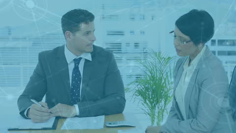 Diverse Business Professionals Discussing at Modern Office Desk