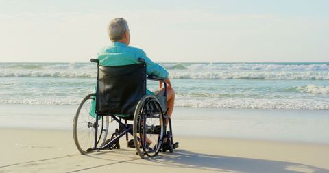 Senior man in wheelchair enjoying tranquil beach view