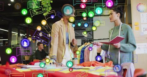 Fashion designers collaborating over fabrics, color swatches and garment prototypes