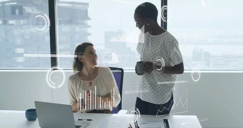 Two Colleagues Discussing Data Analytics with Augmented Reality Overlays in Office