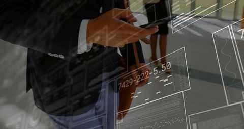 Business Executive Using Tablet with Digital Data Interfaces in Office