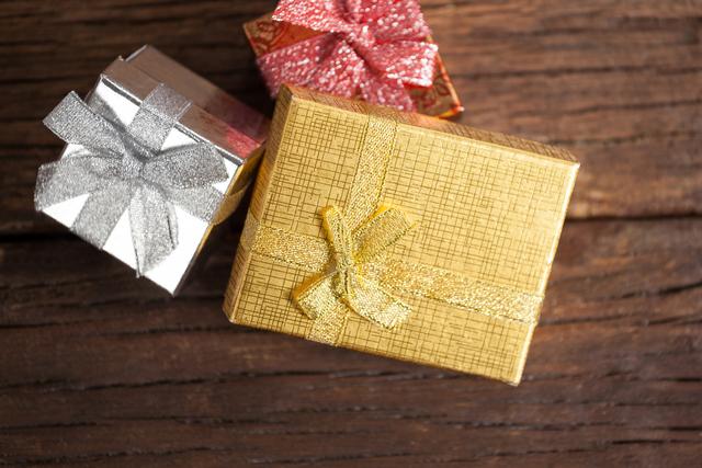 Wrapped Gift Boxes on Wooden Table During Christmas Time - Download Free Stock Photos Pikwizard.com