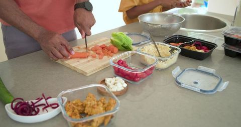 African american father and son preparing healthy meal together in bright home kitchen