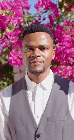 Smiling African American Man Portrait with Vibrant Blossoms
