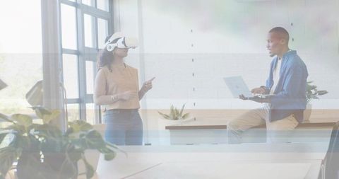 Collaborative vr demonstration with laptop in bright modern office for business innovation