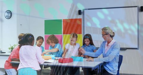 Female Teacher Engaging with Diverse Group of Students in Classroom