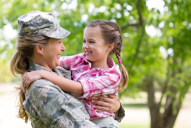 Happy Female Soldier Embracing Daughter in Park - Download Free Stock Photos Pikwizard.com