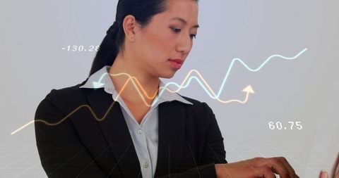 Chinese businesswoman analyzing financial charts on laptop with glowing analytics overlays