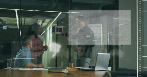 Business Team Analyzing Data on Bar Chart in Modern Office