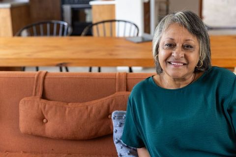 Happy Senior African American Woman Relaxing in Stylish Living Room