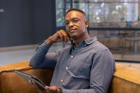 Business Professional Contemplating in Modern Office Lounge