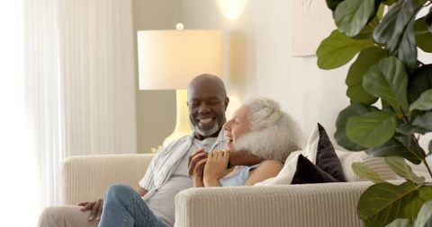 Senior Couple Sharing a Laugh in Cozy Living Room Environment