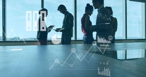 Diverse team collaborating with digital data analysis in modern office