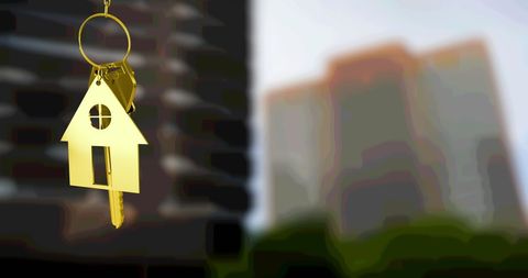 Gold House Key with Urban Apartments in Background - Download Free Stock Images Pikwizard.com