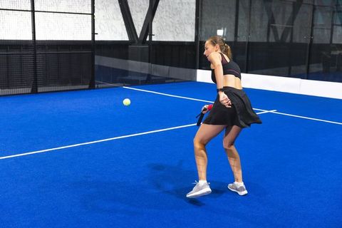Female Athlete Elevating Game on Paddle Court