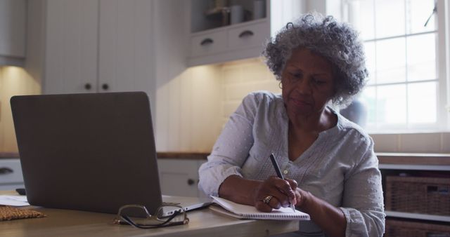 Senior Woman Taking Notes While Working on Laptop - Download Free Stock Images Pikwizard.com