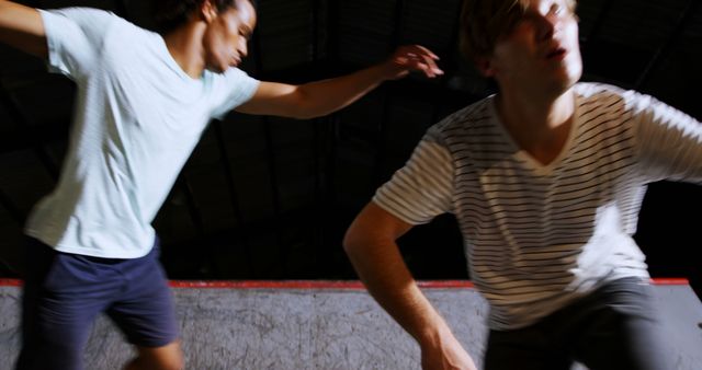 Two Young Men Skateboarding in a Halfpipe Under Bright Lights - Download Free Stock Images Pikwizard.com