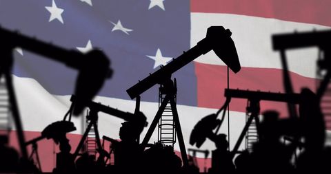 Pump Jacks Silhouetted Against American Flag Background