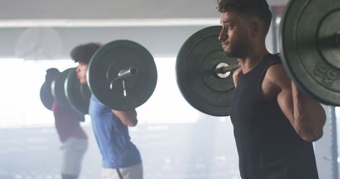 Men Weightlifting in Gym Focusing on Strength Training