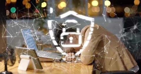 Exhausted businesswoman resting on desk with digital shield overlay