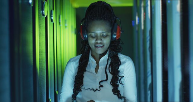 Female IT Specialist Working in Data Center With Protective Headphones - Download Free Stock Images Pikwizard.com
