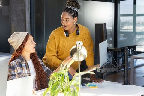 Collaborative Female Colleagues in Modern Office Setting