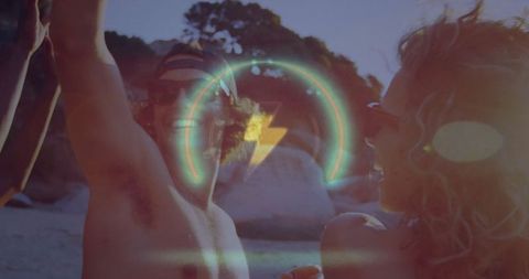 Shirtless Friends Celebrating on Sunny Beach with Light Flare