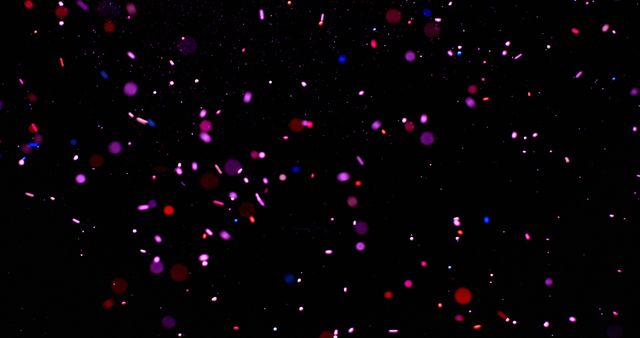 Colorful confetti dots float in a dark background, ideal for festive designs. Captures the essence of celebration, perfect for party-themed graphics or invitations.