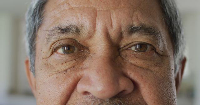 Elderly man's eyes showing deep wrinkles, serious expression, close-up view - Download Free Stock Images Pikwizard.com