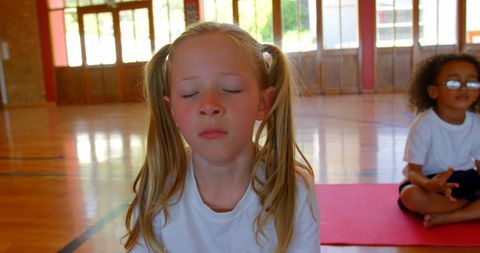 Children Meditating in School Gym with Focus