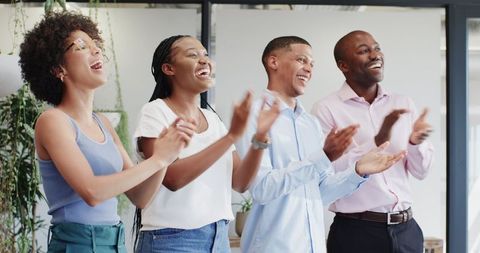 Diverse team applauding corporate success