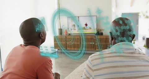 Black father and son watching holographic ar interface in living room for family tech