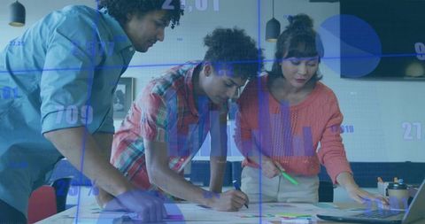 Multiethnic Team Analyzing Data with Digital Charts Overlay