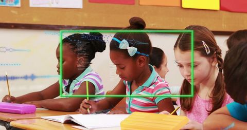 Diverse Schoolchildren Engaged in Writing with Data Visualization Overlay