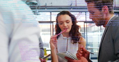 Business Professionals Analyzing Code in Modern Office Setting