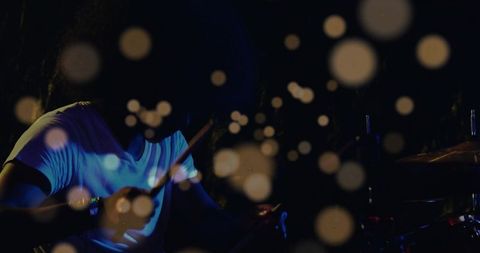 Drummer Under Stage Lights Creating Vibrant Beats