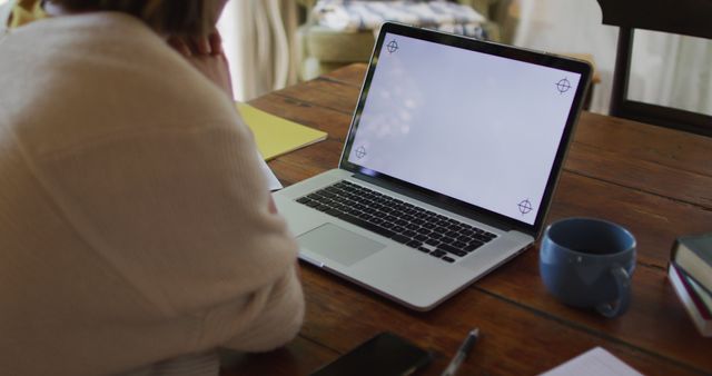 Person Working From Home With Blank Laptop Screen Across Rustic Table - Download Free Stock Images Pikwizard.com