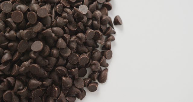 Close-Up of Dark Chocolate Chips Piled on White Background - Download Free Stock Images Pikwizard.com