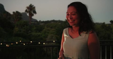 Smiling woman enjoying scenic evening outdoors