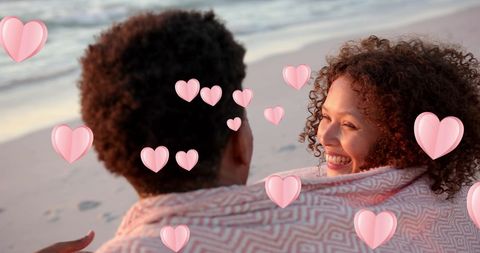 Romantic couple embracing at beach with animated hearts