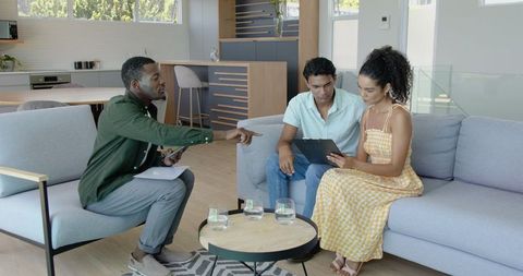 Couple consulting with advisor at home for financial planning
