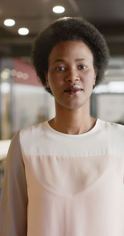 Confident businesswoman standing at office workspace