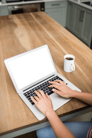 woman typing on laptop with coffee in bright kitchen - Download Free Stock Videos Pikwizard.com