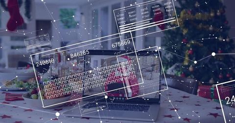 Laptop displaying augmented reality overlays on festive dining table with christmas tree
