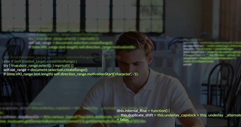 Young man coding on tablet in coffee shop with code overlay, focused on software development