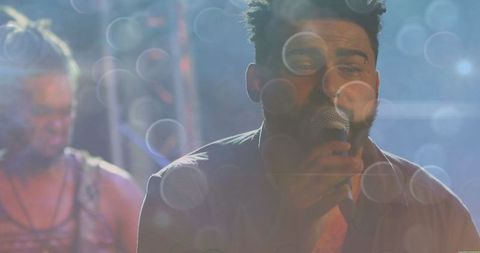 Male Singer Performing at a Nightclub Stage with Guitarist