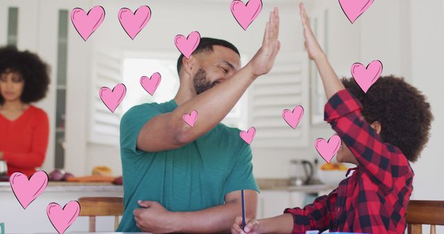 Father and son high-fiving each other, with pink hearts around them, demonstrating joy and celebration. Ideal for parenting blogs, family activity promotions, and advertising bonding time products.