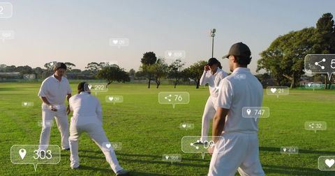 Four cricketers practicing fielding drills on sunlit club ground in white uniforms